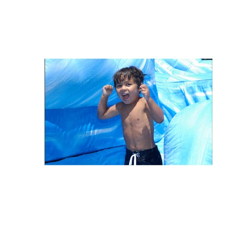 boy playing inside the blue bounce house